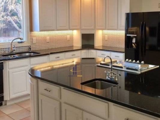 Không gian bếp sang trọng, hiện đại với mặt bếp và bàn đảo được gia công bằng đá granite đen bóng gương từ HOANTHIEN STONE.
